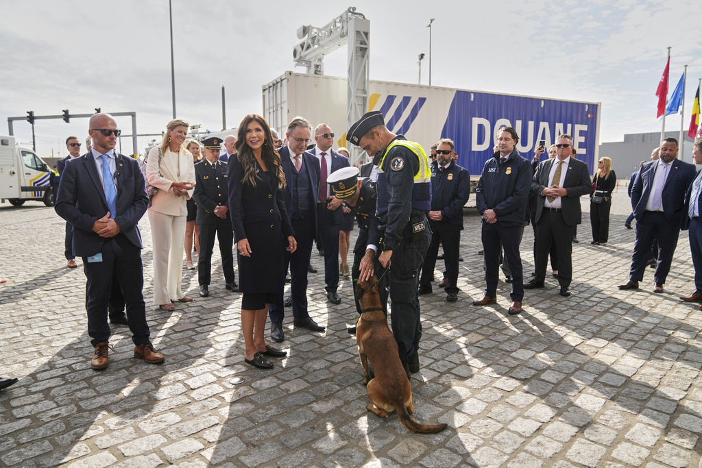 United States Secretary of Homeland Security Kristi Noem greets a container sniffing dog called Emma during a visit to the Port of Antwerp in Antwerp, Belgium, Wednesday, Sept. 10, 2025. (AP Photo/Virginia Mayo)