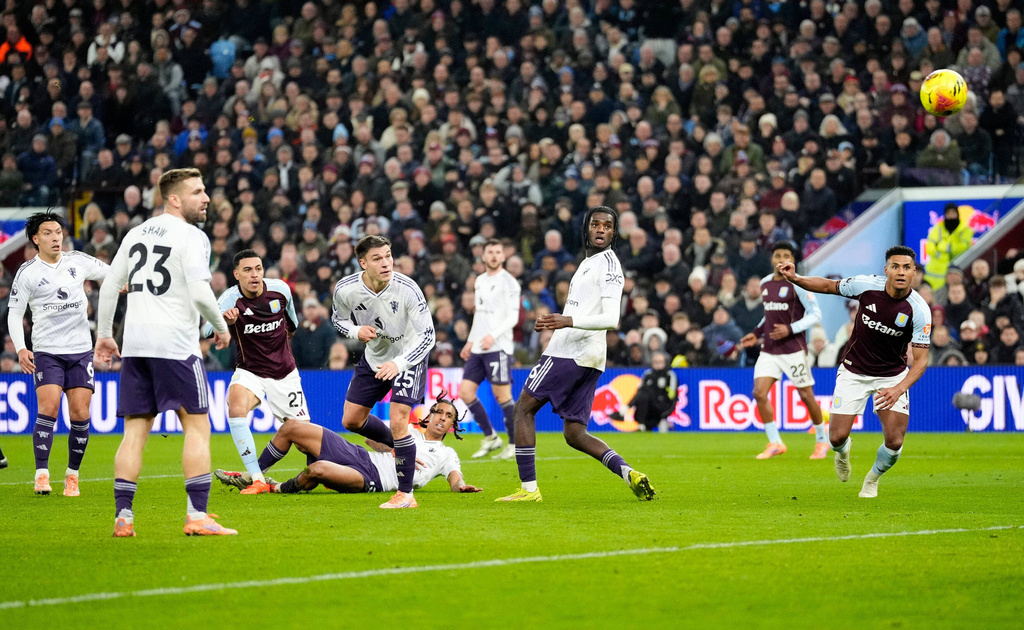 Aston Villa's Morgan Rogers, third left, scores their side's second goal of the game during the Premier League soccer match between Aston Villa and Manchester United, in Birmingham, England, Sunday Dec. 21, 2025. (Nick Potts/PA via AP)