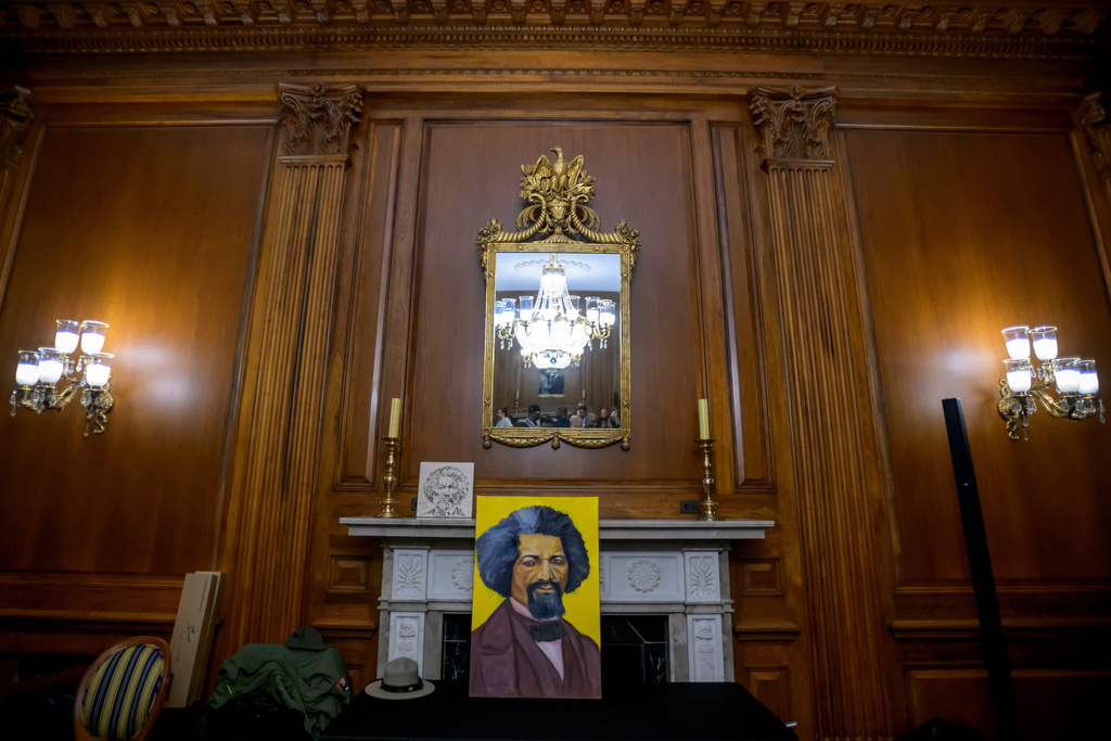 Artwork portraying Frederick Douglass rests on a table during a formal dedication of the House Press Gallery to be named after Frederick Douglass on Capitol Hill, Thursday, Feb., 12, 2026, in Washington. (AP Photo/Rod Lamkey, Jr.)