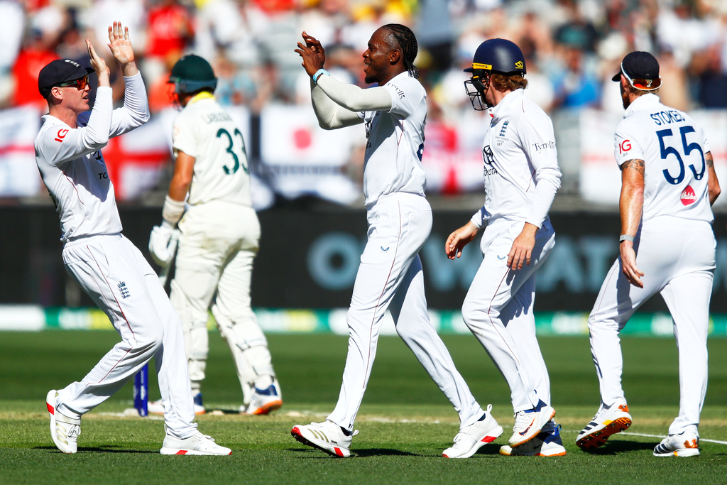 England's Jofra Archer, center, celebrates with teammates the wicket of Australia's Marnus Labuschagne during the first Ashes cricket test match between Australia and England in Perth, Friday, Nov. 21, 2025.(AP Photo/Gary Day)