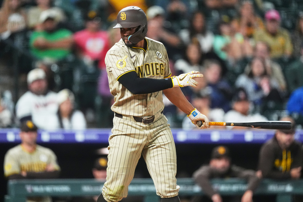 San Diego Padres' Xander Bogaerts strikes out agianst Colorado Rockies relief pitcher Ryan Feltner in the eighth inning of a baseball game Tuesday, Sept. 15, 2026, in Denver. (AP Photo/David Zalubowski)