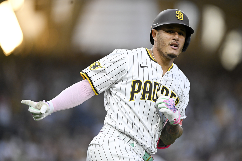 San Diego Padres' Manny Machado celebrates after hitting a solo home run during the third inning of a baseball game against the Colorado Rockies, Saturday, Sept. 13, 2025, in San Diego. (AP Photo/Denis Poroy)