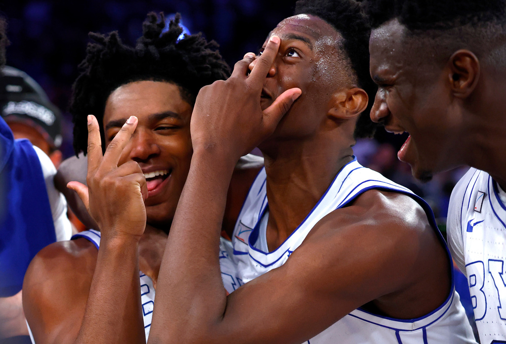 BYU guard Robert Wright III , left and forward AJ Dybantsa, right, reacts after defeating Clemson an NCAA basketball game, Tuesday, Dec. 9, 2025, in New York. (AP Photo/Noah K. Murray)