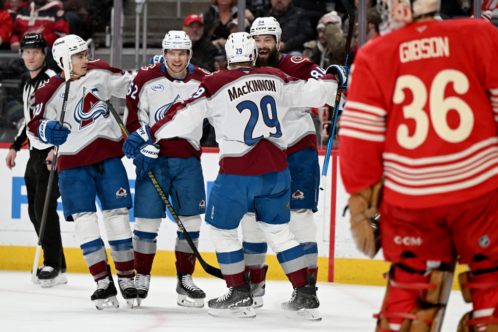 Colorado Avalanche defenseman Brent Burns (84) celebrates with Colorado defenseman Sam Malinski (70), Colorado left wing Artturi Lehkonen (62) and Colorado center Nathan MacKinnon (29) after scoring a goal against Detroit in the first period of an NHL hockey game Saturday, Jan. 31, 2026 in Detroit. (AP Photo/Lon Horwedel)