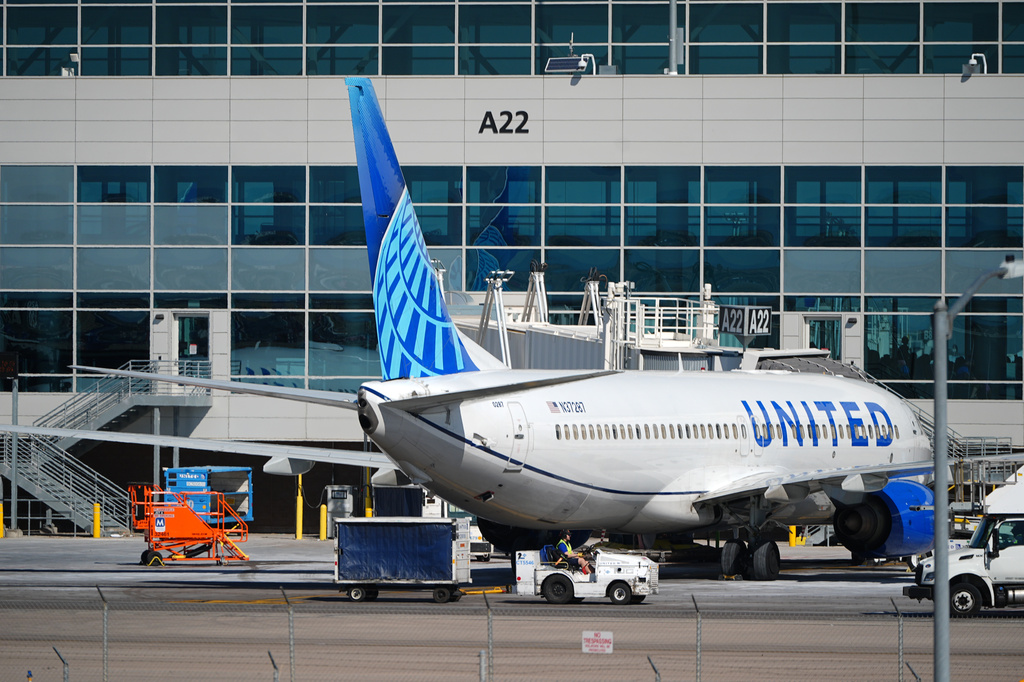 FILE - A United Airlines jetliner sits at a gate along the A concourse of Denver International Airport, March 20, 2026, in Denver. (AP Photo/David Zalubowski, File)