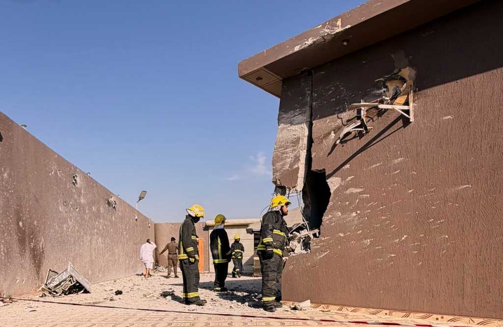 This photo provided by the Saudi Press Agency shows firefighters inspecting damage to a building caused by falling debris from a drone that Saudi authorities said was launched by Yemen's Houthi rebels and intercepted over Taif province, western Saudi Arabia, Thursday, Sept. 17, 2026. (Saudi Press Agency via AP)