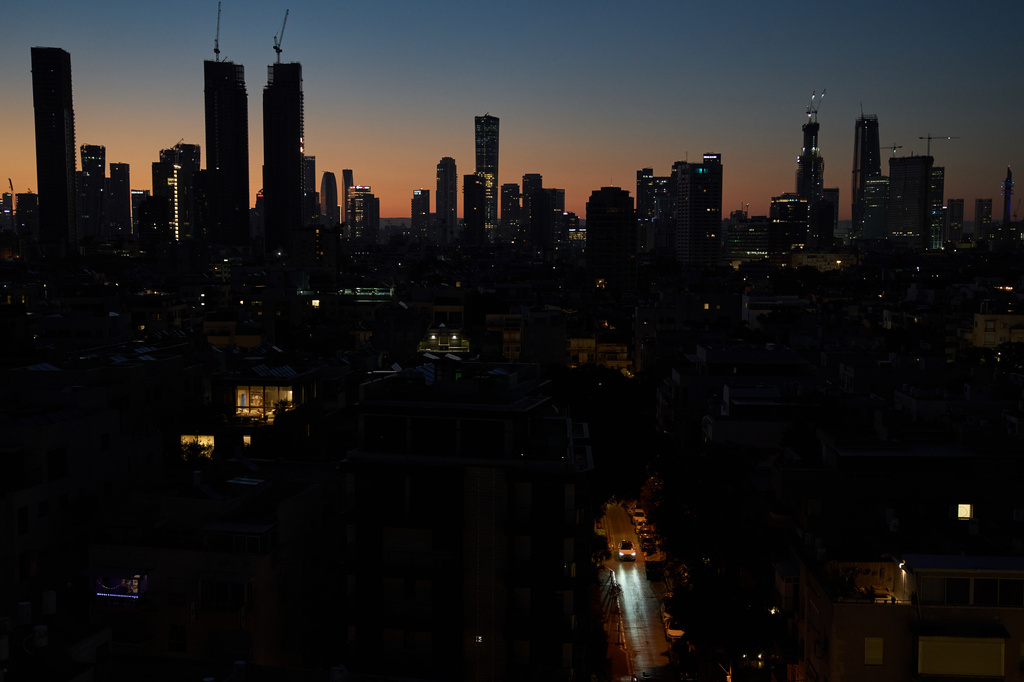 A car moves down a street in the early morning in Tel Aviv, Israel, Wednesday, April 22, 2026, following the announcement by U.S. President Donald Trump that he was extending the ceasefire with Iran. (AP Photo/Leo Correa)