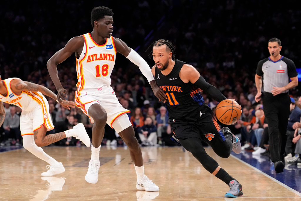 New York Knicks guard Jalen Brunson (11) drives past Atlanta Hawks forward Mouhamed Gueye (18) during the first half in Game 2 of a first-round NBA playoffs basketball series, Monday, April 20, 2026, in New York. (AP Photo/Yuki Iwamura)