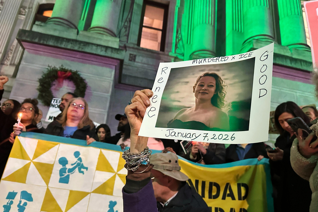 People gather at an anti-immigration enforcement rally and vigil for Renee Good, a Minneapolis woman who was shot and killed by an Immigration and Customs Enforcement officer in Minnesota, Thursday, Jan. 8, 2026, in Philadelphia. (AP Photo/Tassanee Vejpongsa)