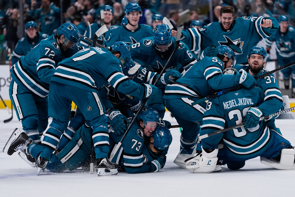 San Jose Sharks center Tyler Toffoli (73) celebrates with teammates after scoring the game-winning goal during overtime of an NHL hockey game against the Dallas Stars, Saturday, Jan. 10, 2026, in San Jose, Calif. (AP Photo/Godofredo A. Vásquez)