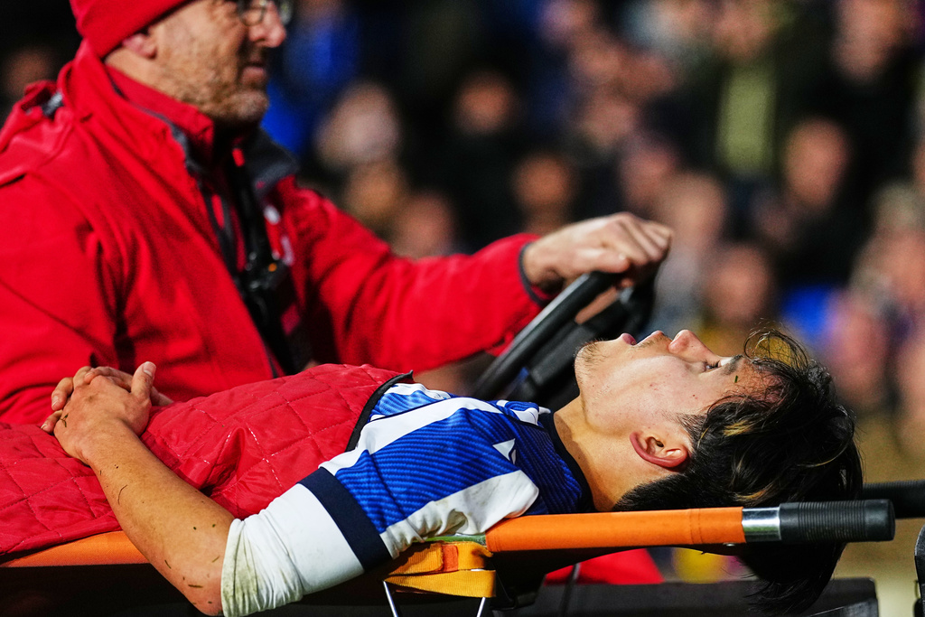 Real Sociedad's Takefusa Kubo is transported off the pitch during the Spanish La Liga soccer match between Real Sociedad and Barcelona in San Sebastian, Spain, Sunday, Jan. 18, 2026. (AP Photo/Miguel Oses)