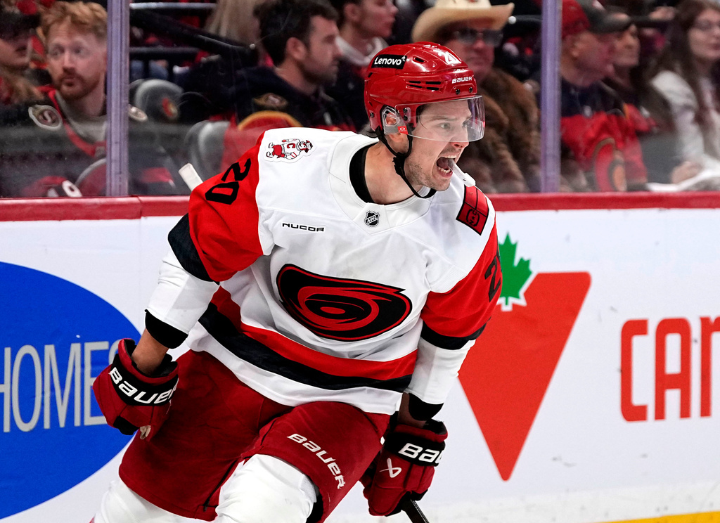 Carolina Hurricanes' Sebastian Aho (20) celebrates scoring an empty net goal against the Ottawa Senators in the third period in Game 4 of a first-round NHL Stanley Cup playoff hockey series, Saturday, April 25, 2026, in Ottawa, Ontario. (Justin Tang/The Canadian Press via AP)