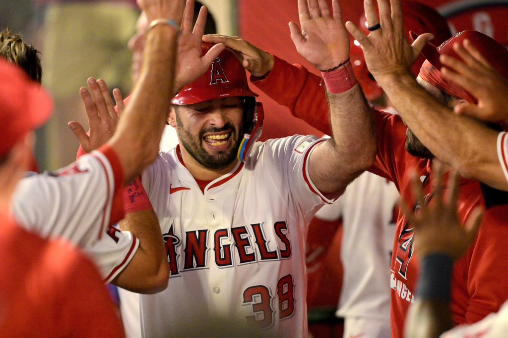 Los Angeles Angels' Sebastian Rivero is congratulated in the dugout after scoring during the second inning of a baseball game against the Minnesota Twins, Monday, Sept. 8, 2025, in Anaheim, Calif. (AP Photo/Jayne Kamin-Oncea)