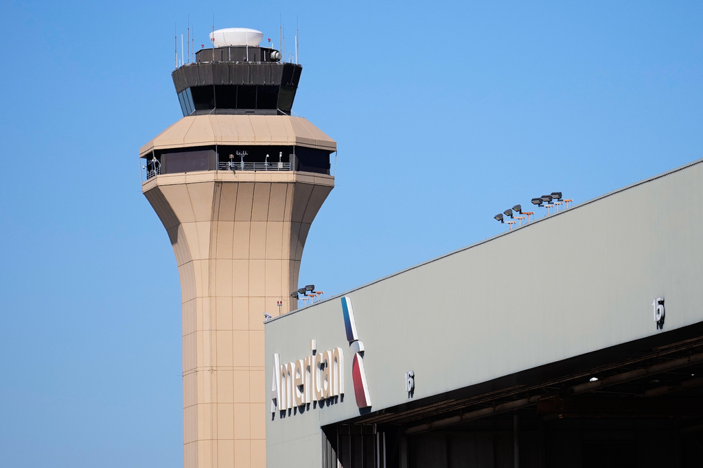 FILE - A control tower by an American Airlines hangar is shown at Dallas Fort Worth International Airport, Oct. 15, 2025, in DFW Airport, Texas. (AP Photo/Tony Gutierrez, file)