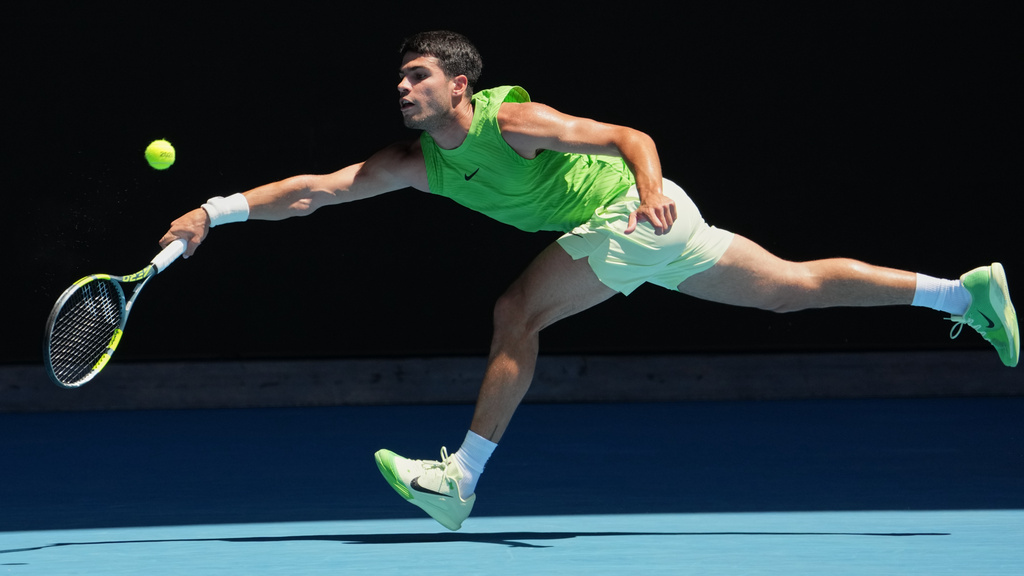 Carlos Alcaraz of Spain plays a forehand return to Yannick Hanfmann of Germany during their second round match at the Australian Open tennis championship in Melbourne, Australia, Wednesday, Jan. 21, 2026. (AP Photo/Dita Alangkara)