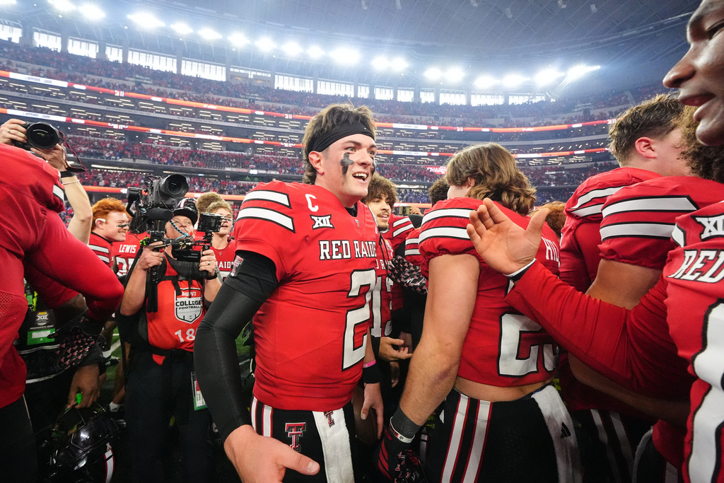 FILE - Texas Tech quarterback Behren Morton (2) celebrates with teammates after their win against BYU in the Big 12 Conference championship NCAA college football game Saturday, Dec. 6, 2025, in Arlington, Texas. (AP Photo/Julio Cortez, File)