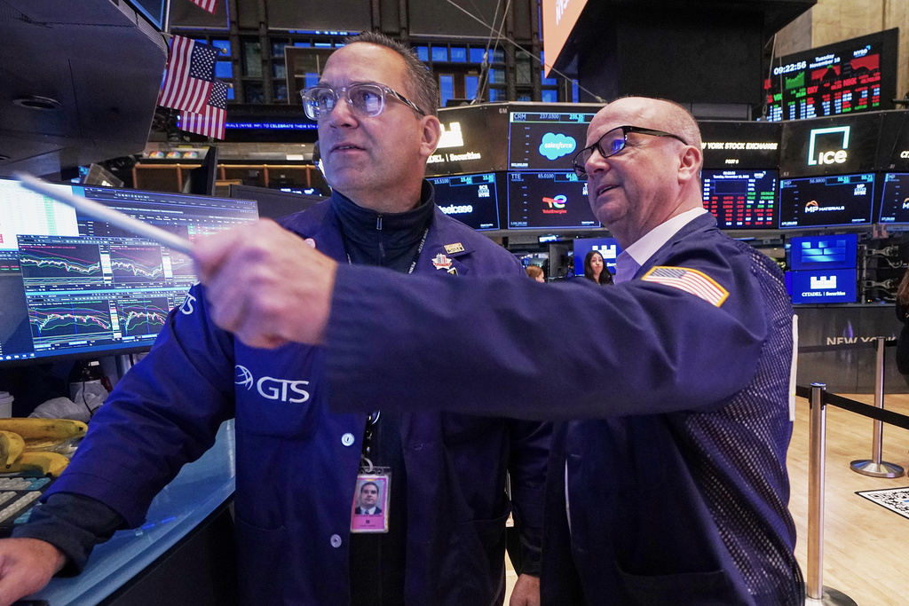 Specialist Anthony Matesic, left, and trader Patrick Casey work on the floor of the New York Stock Exchange, Tuesday, Nov. 18, 2025. (AP Photo/Richard Drew)