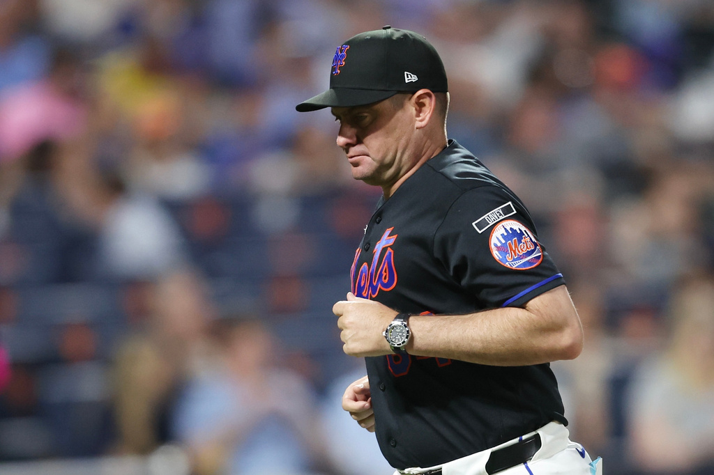 New York Mets manager Carlos Mendoza (64) returns to the dugout after a pitching change during the sixth inning of a baseball game against the Chicago Cubs, Thursday, June 25, 2026, in New York. (AP Photo/Heather Khalifa)