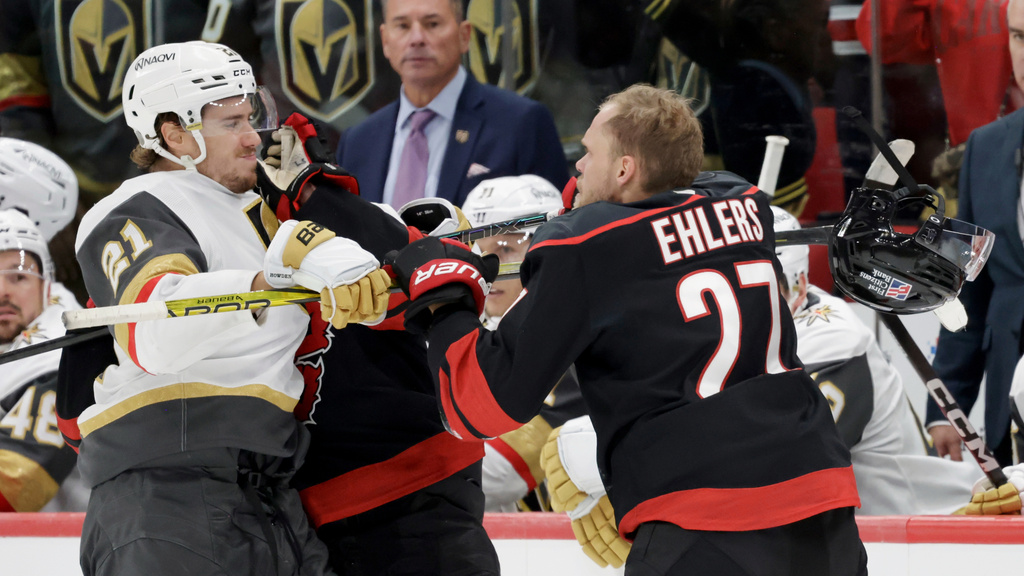 FILE - Vegas Golden Knights center Brett Howden (21) mixes it up with Carolina Hurricanes left wing Nikolaj Ehlers (27) during the third period of an NHL hockey game Oct. 28, 2025, in Raleigh, N.C. (AP Photo/Chris Seward, File)