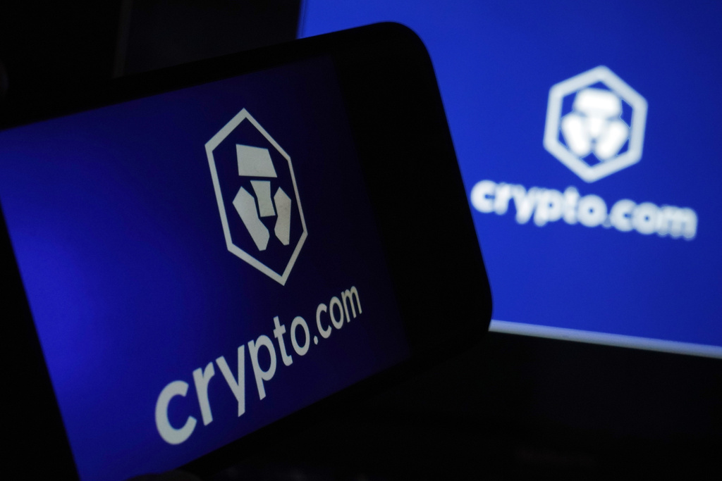 FILE - The logo for crypto.com appears on a mobile phone and computer screen, in New York, Jan. 31, 2023. (AP Photo/Richard Drew, file)
