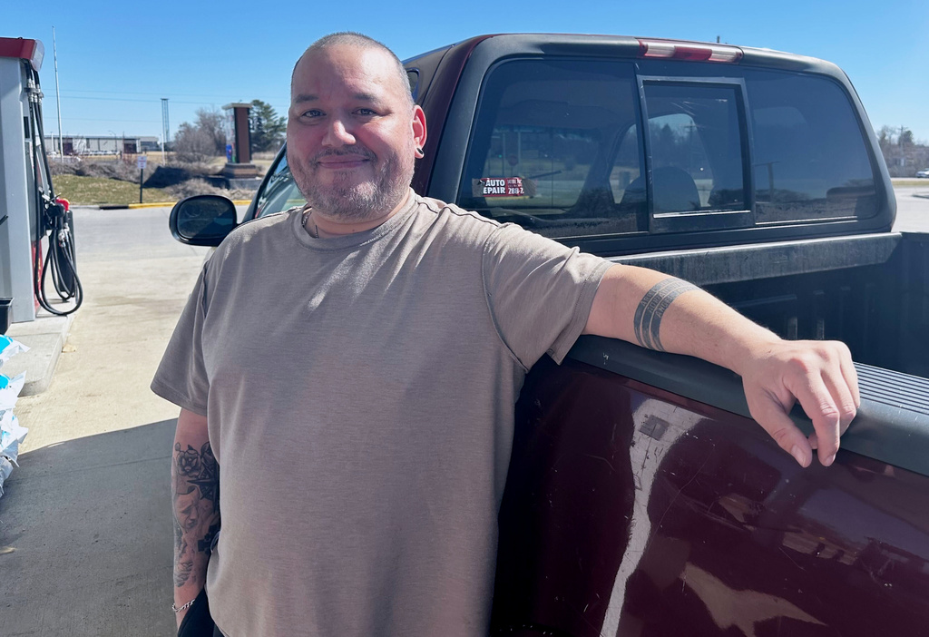 Francisco Castillo stands next to his son's Ford F-150 after filling up, Monday, March 9, 2026, at a gas station in De Soto, Iowa. (AP Photo/Hannah Fingerhut)