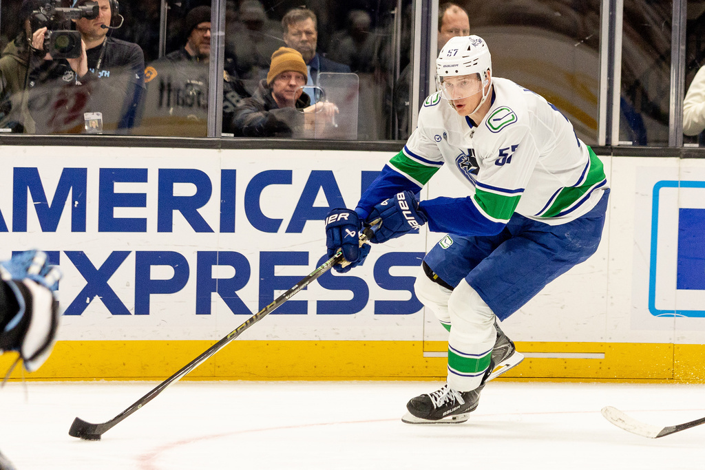 Vancouver Canucks defenseman Tyler Myers looks to move the puck to the goal during the second period of an NHL hockey game against the Utah Mammoth, Monday, Feb. 2, 2026, in Salt Lake City. (AP Photo/Melissa Majchrzak)