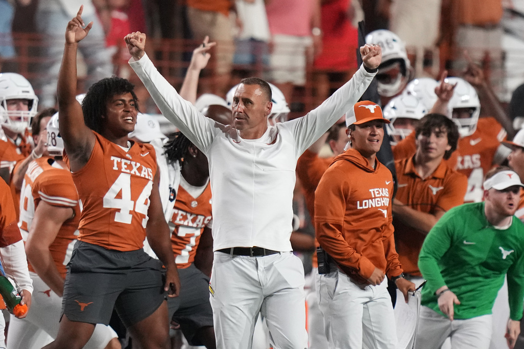 Texas head coach Steve Sarkisian, center, celebrates Texas' win over Ohio State in an NCAA college football game in Austin, Texas, Saturday, Sept. 12, 2026. (AP Photo/Eric Gay)
