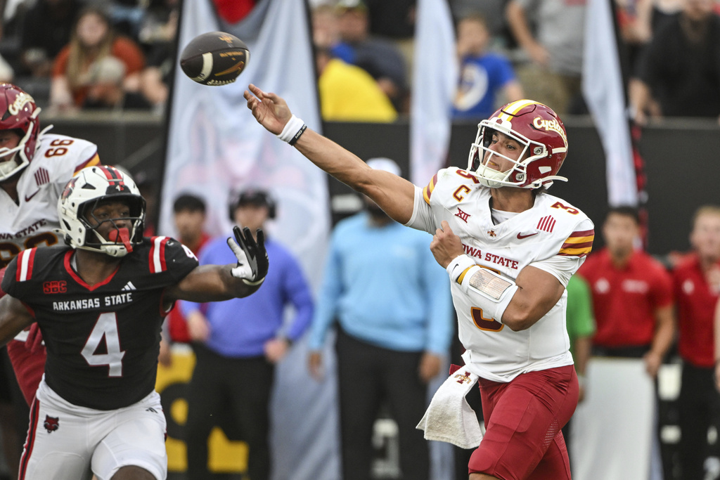 Iowa State quarterback Rocco Becht (3) throws a pass while under pressure from Arkansas State defensive end Bryan Whitehead (4) during an NCAA college football game Saturday, Sept. 13, 2025, in Jonesboro, Ark. (AP Photo/Michael Woods)