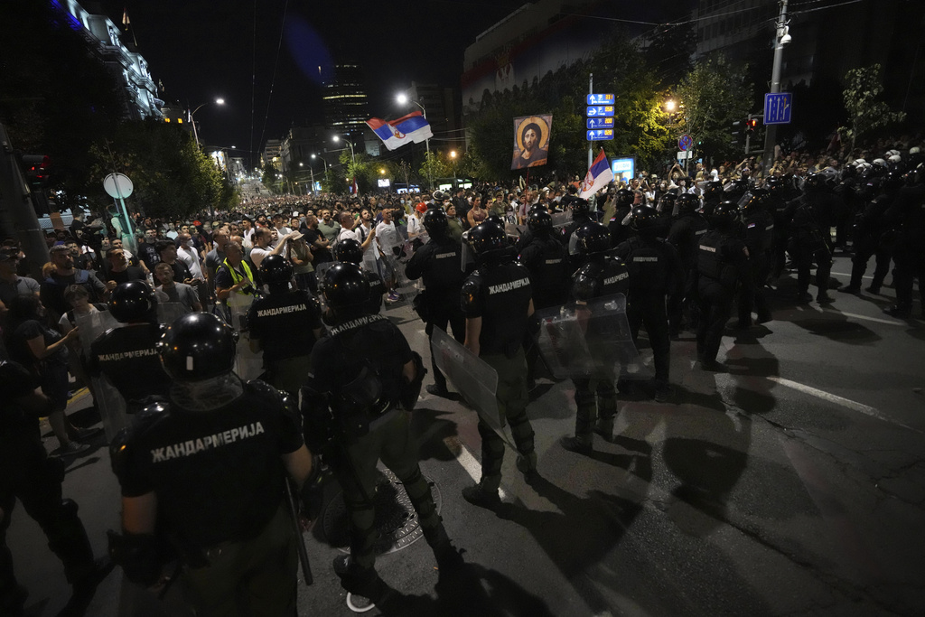 Serbian police officers block protesters during an anti-government protest in Belgrade, Serbia, Thursday, Aug. 14, 2025. (AP Photo/Darko Vojinovic)