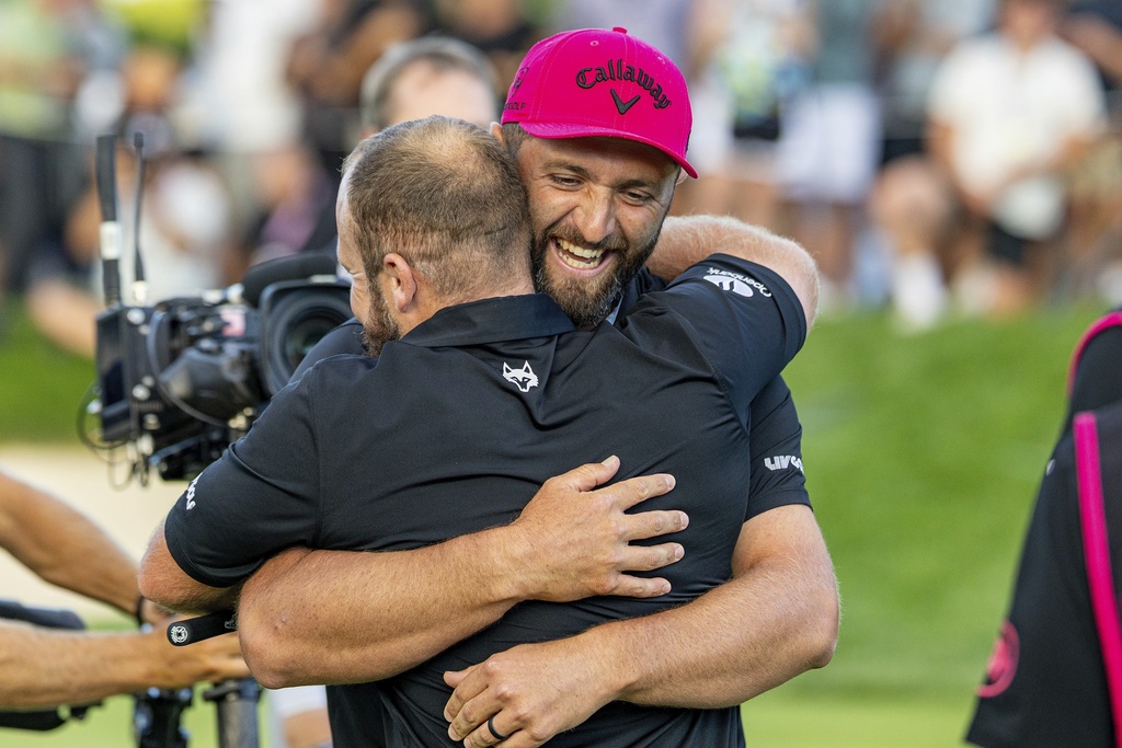 Team Champions captain Jon Rahm, right, and Tyrrell Hatton, left, both of Legion XIII, celebrate on the 18th green following the final round of LIV Golf Team Championship Michigan at The Cardinal at Saint John's, Sunday, Aug. 24, 2025, in Plymouth, Mich. (Scott Taetsch/LIV Golf via AP)