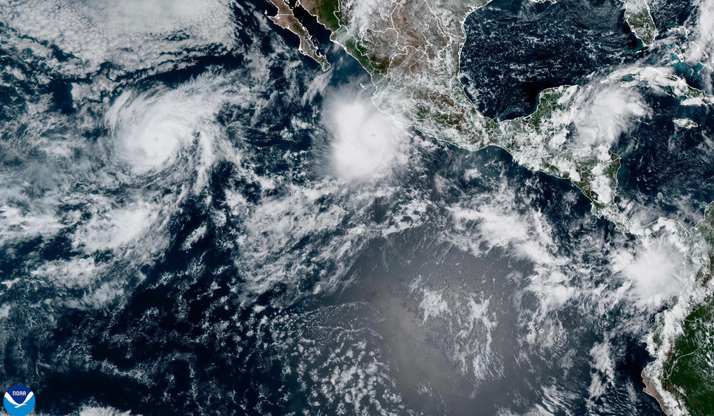This satellite image provided by NOAA shows Hurricane Polo off the southwestern coast of Mexico and Hurricane Odalys, left, on Thursday, Sept. 24, 2026. (NOAA via AP) CORRECTION: Changes to Hurricane Odalys, not Tropical Storm Nolo.