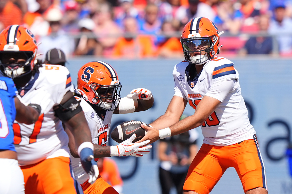 Syracuse quarterback Rickie Collins (10) hands off to running back Yasin Willis (6) during the first half of an NCAA college football game against SMU, Saturday, Oct. 4, 2025, in Dallas. (AP Photo/LM Otero)