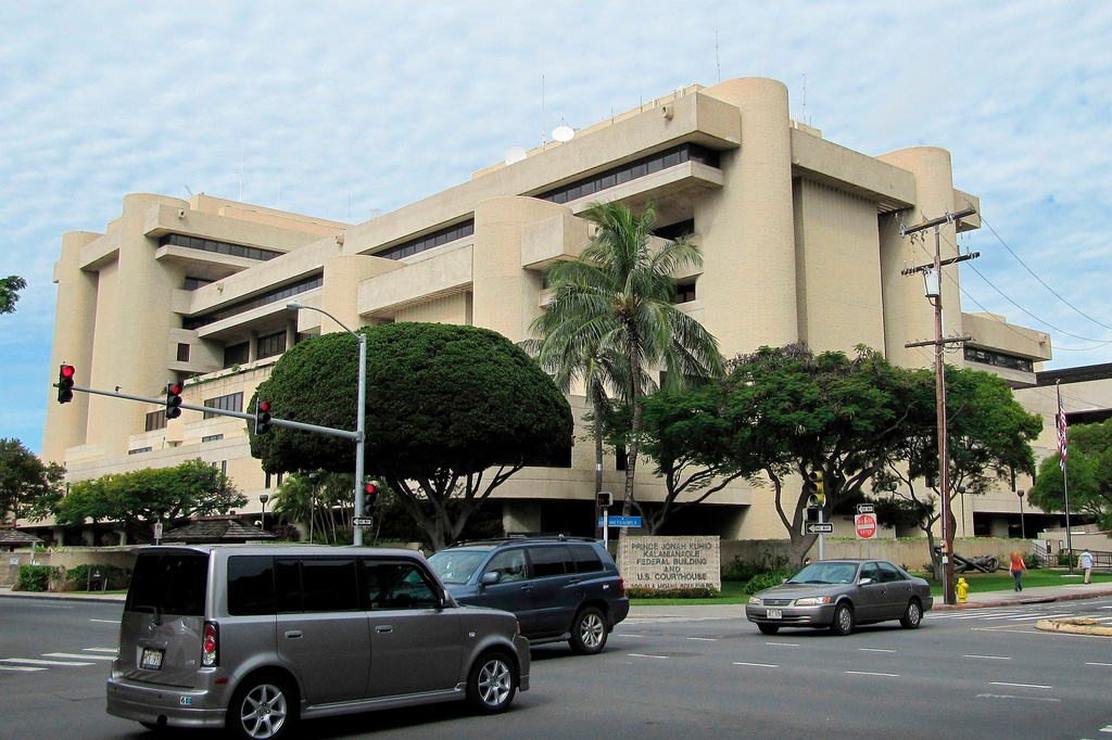 FILE - Cars pass in front of the federal building housing the U.S. District Court in Honolulu on March 7, 2014. (AP Photo/Jennifer Sinco Kelleher, File)