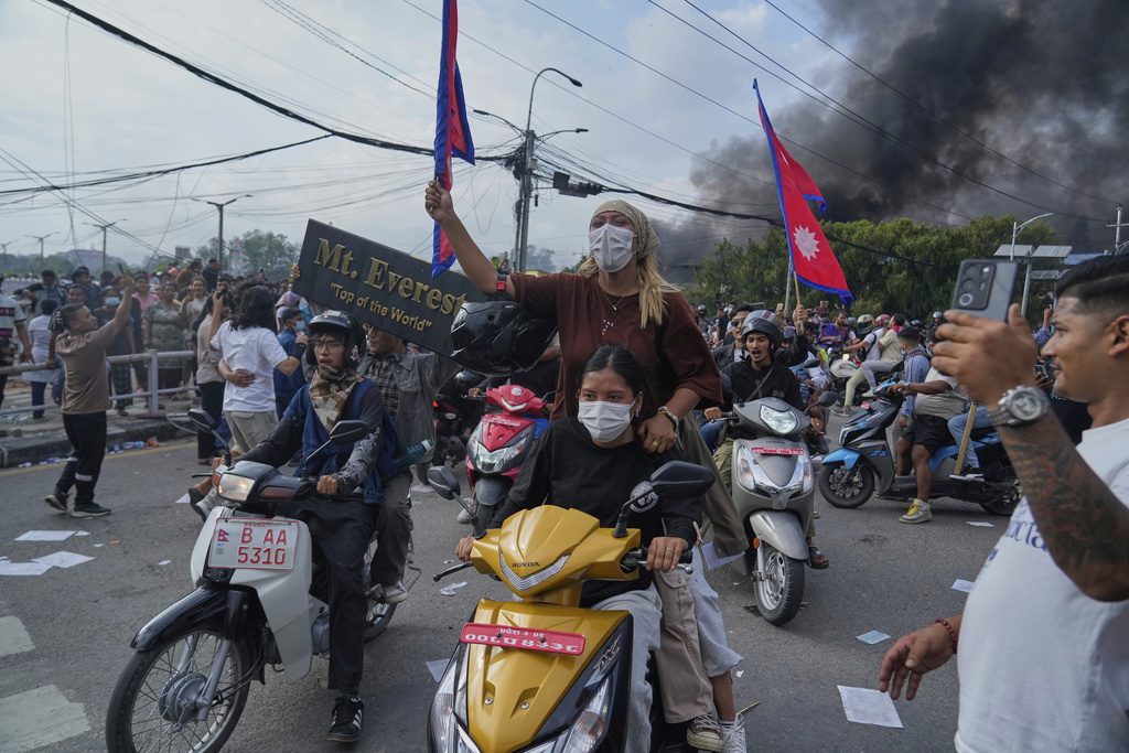 Protesters shout slogans during a protest against a social media ban and corruption in Kathmandu, Nepal, Tuesday, Sept. 9, 2025. (AP Photo/Niranjan Shrestha)