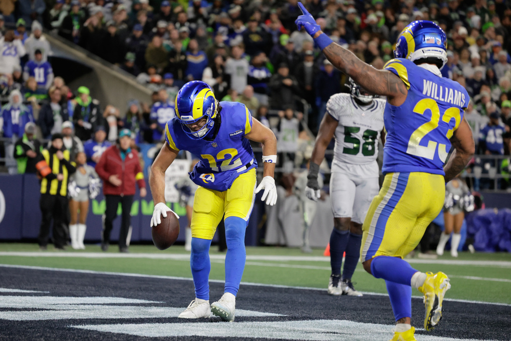 Los Angeles Rams wide receiver Puka Nacua (12) scores a touchdown during the second half of an NFL football game against the Seattle Seahawks, Thursday, Dec. 18, 2025, in Seattle. (AP Photo/John Froschauer)