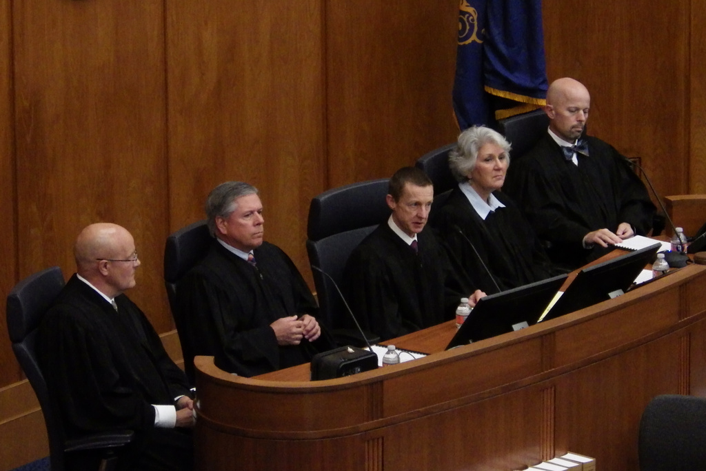 North Dakota Supreme Court Chief Justice Jon Jensen, center, addresses new lawyers during a ceremony, Friday, Sept. 26, 2025, in the North Dakota House of Representatives at the state Capitol in Bismarck, North Dakota. The other justices are, from left, Douglas Bahr, Daniel Crothers, Lisa Fair McEvers and Jerod Tufte. (AP Photo/Jack Dura)