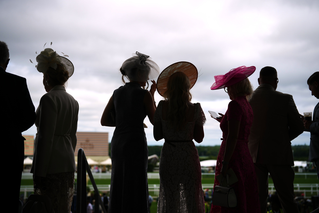 Racegoers are silhouetted as they attend the third day of the Royal Ascot horse race meeting, traditionally called Ladies Day in Ascot, England, Thursday, June 18, 2026. (AP Photo/Alastair Grant)