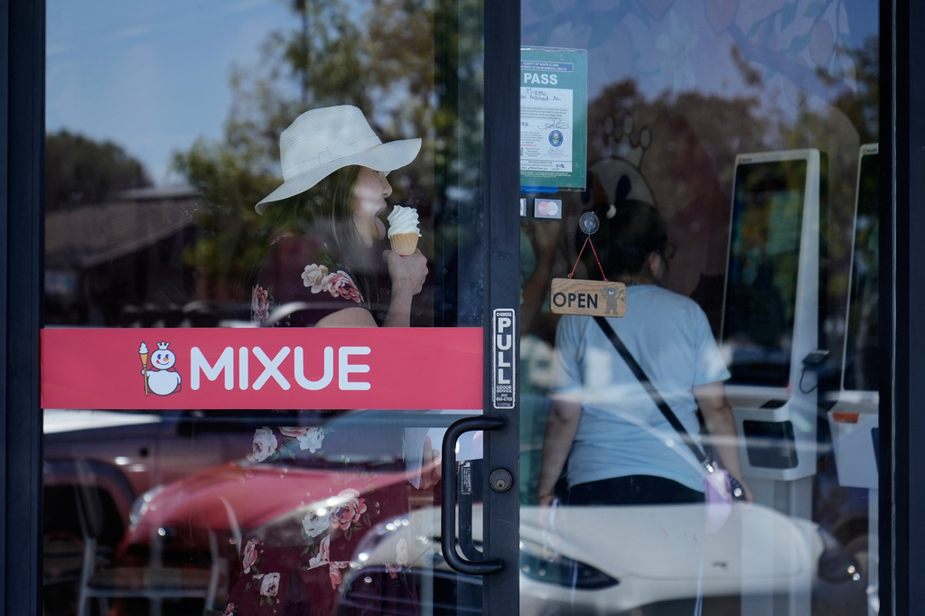A customer holds an ice cream cone while exiting a Mixue store, Wednesday, Sept. 16, 2026, in Sunnyvale, Calif. (AP Photo/Jeff Chiu)