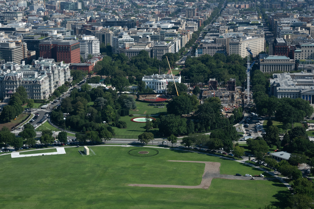Construction continues on the helipad, center, and ballroom, right at White House, Friday, Aug. 7, 2026, in Washington. (AP Photo/Allison Robbert)