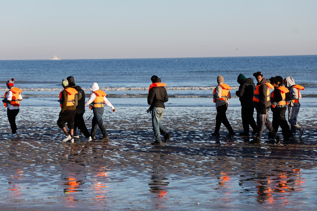 Migrants board a small boat in an attempt to reach Britain, Wednesday, April 8, 2026 in Malo-les-Bains, northern France. (AP Photo/Jean-Francois Badias)