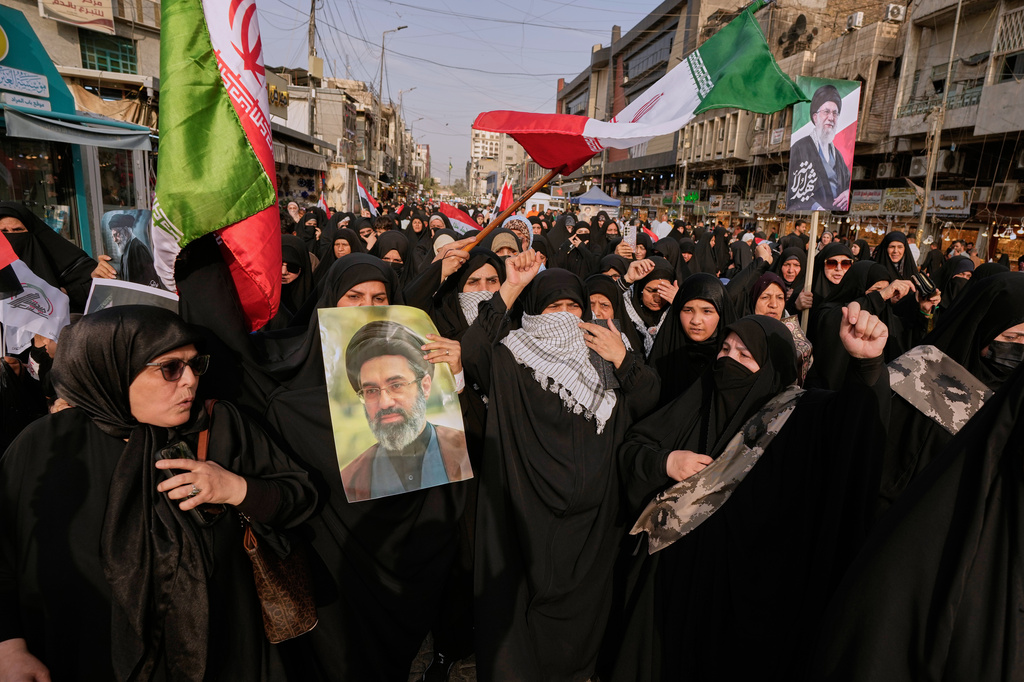 Iraqis Muslim women hold portraits of Iran's late Supreme Leader Ayatollah Ali Khamenei and his son Ayatollah Mojtaba Khamenei, during a protest against U.S. and Israeli attacks on multiple cities across Iran, in Baghdad, Iraq, Saturday, April 25, 2026. (AP Photo/Hadi Mizban)