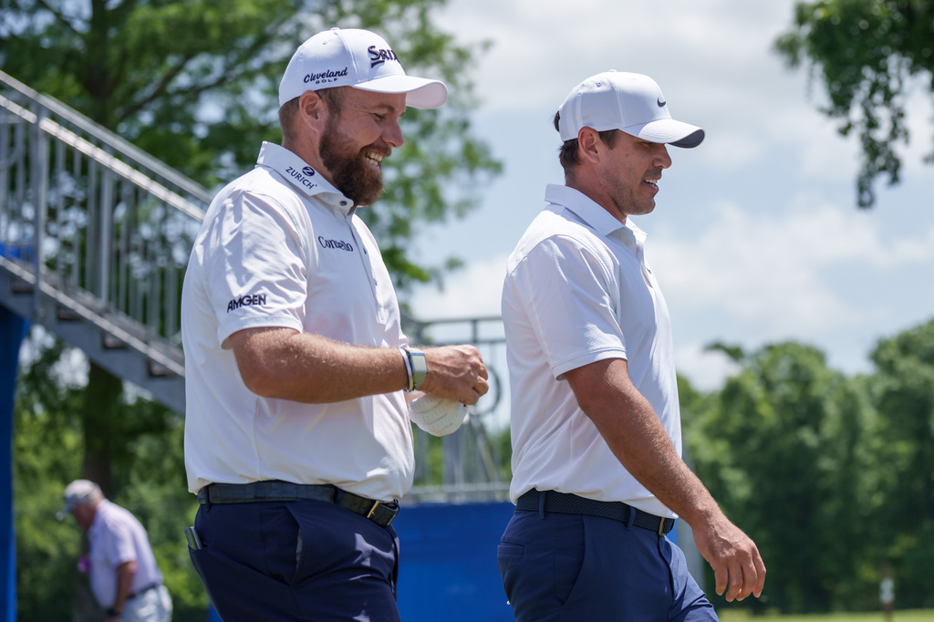 Shane Lowry, left, of Ireland, talks with Brooks Koepka after teeing off on the first hole during the first round of the PGA Zurich Classic golf tournament, Thursday, April 23, 2026, in Avondale, La. (AP Photo/Matthew Hinton)