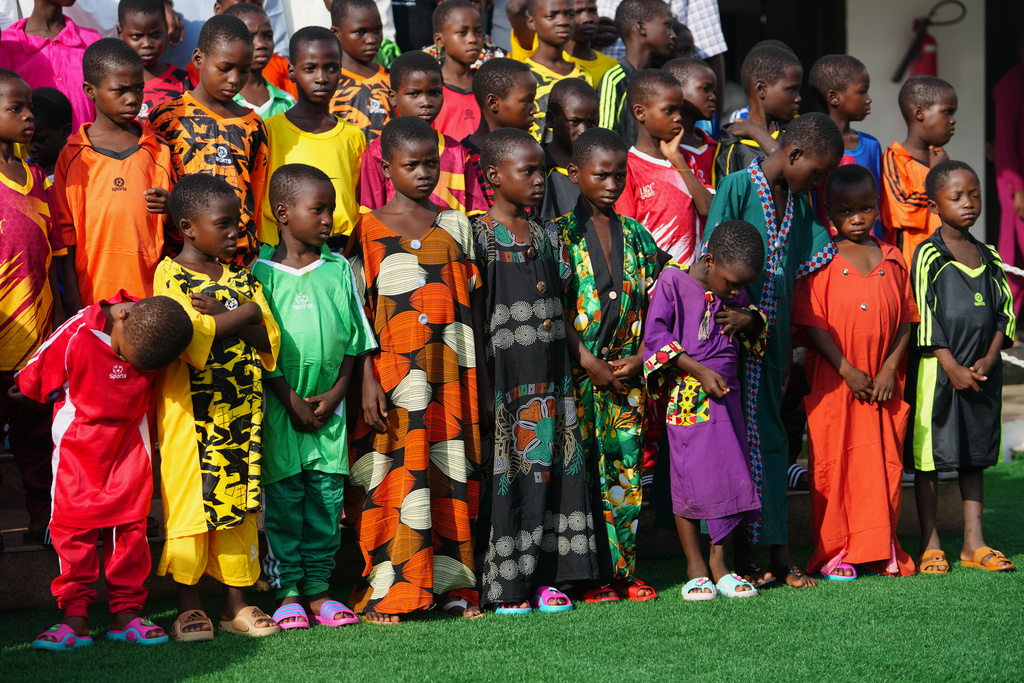 Freed students of St. Mary's Catholic School in the Papiri community pose for photographs upon their arrival at the government house, in Minna, Nigeria, Monday, Dec. 22, 2025. (AP Photo/Sunday Alamba)
