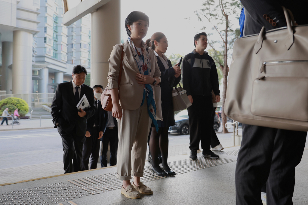 FILE - Selina Cheng, chair of the Hong Kong Journalists Association (HKJA) and a former reporter for The Wall Street Journal (WSJ), arrives at Eastern Magistrates' Court together with her legal team for her case against the paper's parent company, Dow Jones Publishing Co (Asia) Inc., in Hong Kong on Dec 18, 2025. (AP Photo/May James, File)
