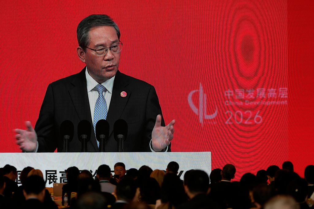 Chinese Premier Li Qiang is displayed on a large screen live broadcasting his speech at the opening of the China Development Forum 2026 held at the Diaoyutai State Guesthouse in Beijing on Sunday, March 22, 2026. (AP Photo/Ng Han Guan, Pool)