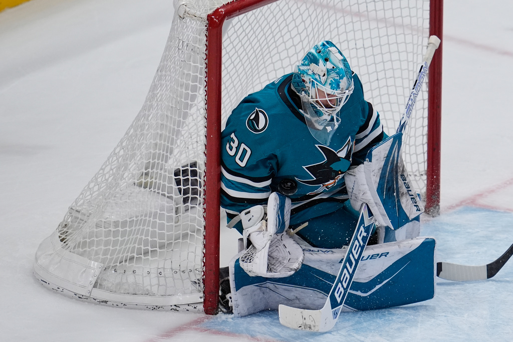 San Jose Sharks goaltender Yaroslav Askarov (30) stops a shot during the third period of an NHL hockey game against the Vancouver Canucks, Friday, Nov. 28, 2025, in San Jose, Calif. (AP Photo/Godofredo A. Vásquez)