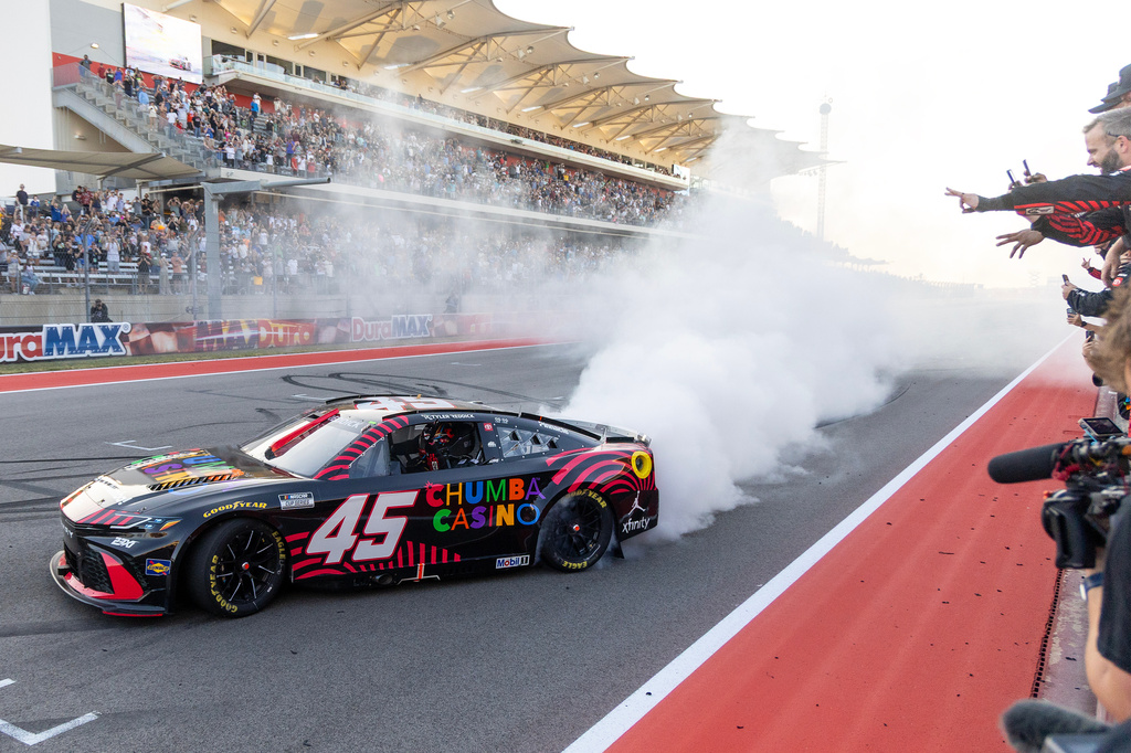 23XI Racing's Tyler Reddick celebrates his win with his team members during a NASCAR Cup Series auto race in Austin, Texas, Sunday, March 1, 2026. (AP Photo/Stephen Spillman)