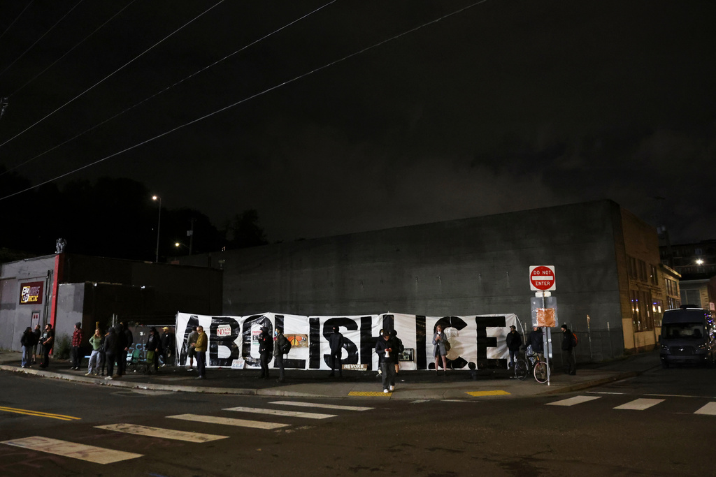 People protest outside a U.S. Immigration and Customs Enforcement facility, in Portland, Oregon, Wednesday, Oct. 1, 2025. (AP Photo/Amanda Loman)