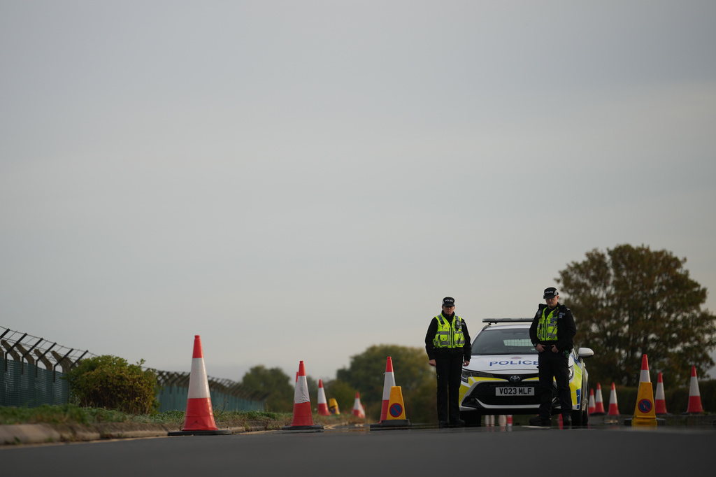 Police officers guard a road leading to RAF Fairford, after an incident in Fairford, England, Monday Sept. 28, 2026. (AP Photo/Alastair Grant)