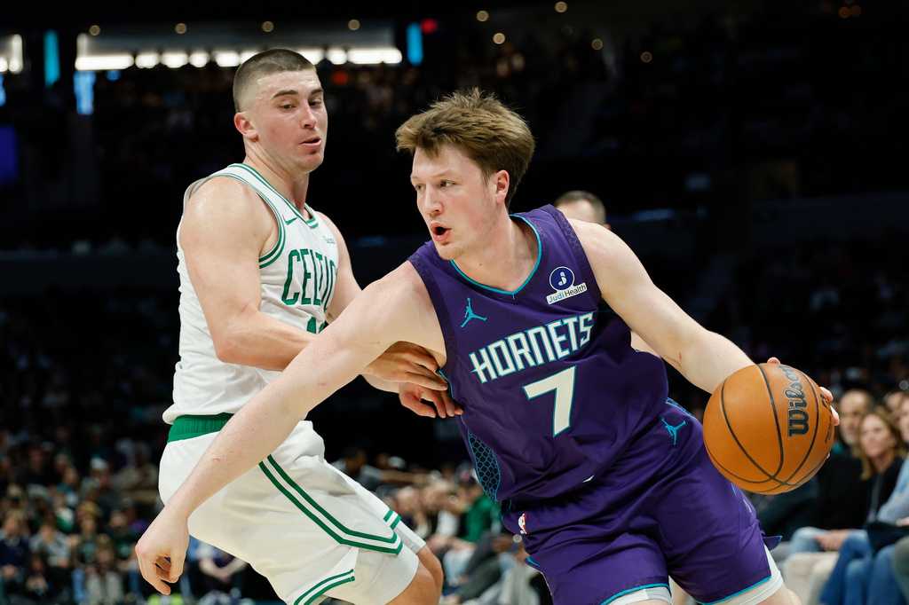 Charlotte Hornets guard Kon Knueppel (7) drives against Boston Celtics guard Payton Pritchard during the first half of an NBA basketball game in Charlotte, N.C., Sunday, March 29, 2026. (AP Photo/Nell Redmond)